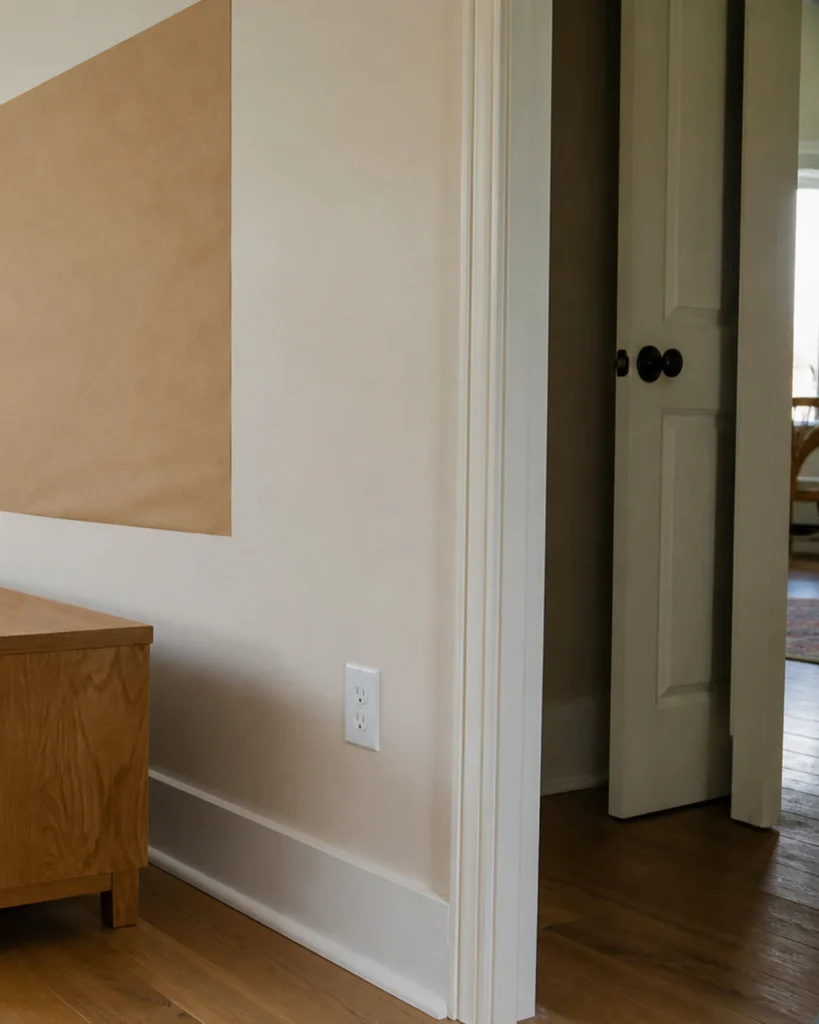Side view of a low wooden media console pulled slightly away from the wall beside a clear doorway, with no television or cables installed.